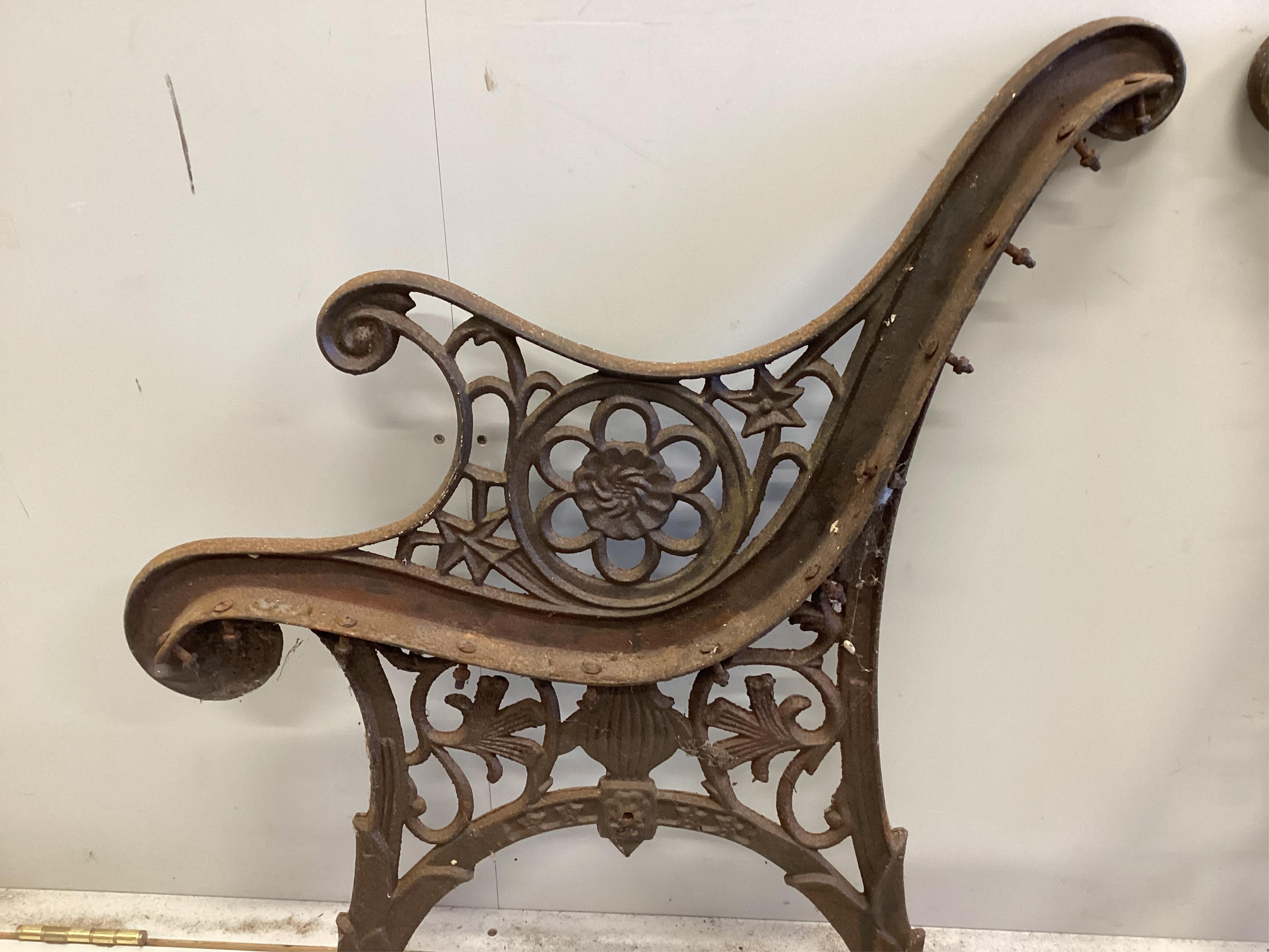 A pair of cast iron bench ends, each width 60cm, height 74cm